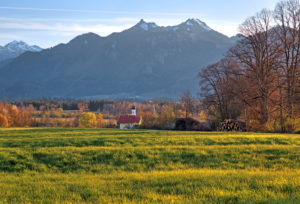 Spring landscape with little church from the hamlet of Weichs against Ettaler Mandl (1633m) and Laber (1686m) of the Ammergau Alps, Ohlstadt, Das Blaue Land, Upper Bavaria, Bavaria, Germany Spring landscape with little church from the hamlet of Weichs against Ettaler Mandl (1633m) and Laber (1686m) of the Ammergau Alps, Ohlstadt, Das Blaue Land, Upper Bavaria, Bavaria, Germany
